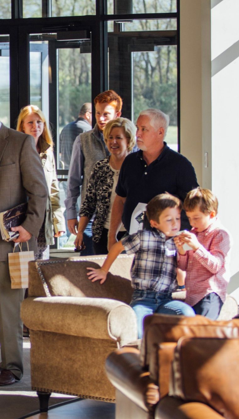 Multi-generational families entering church doors into lobby