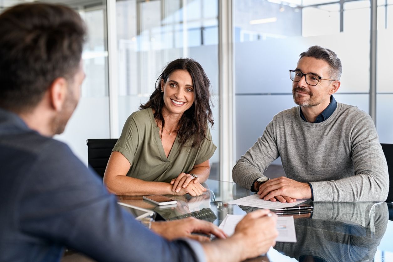 Happy middle aged church staff meeting with insurance agent.